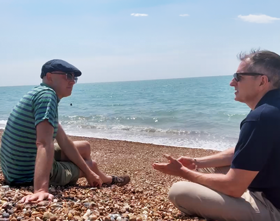 Graham Allcott and Jason Kitts talking on the beach